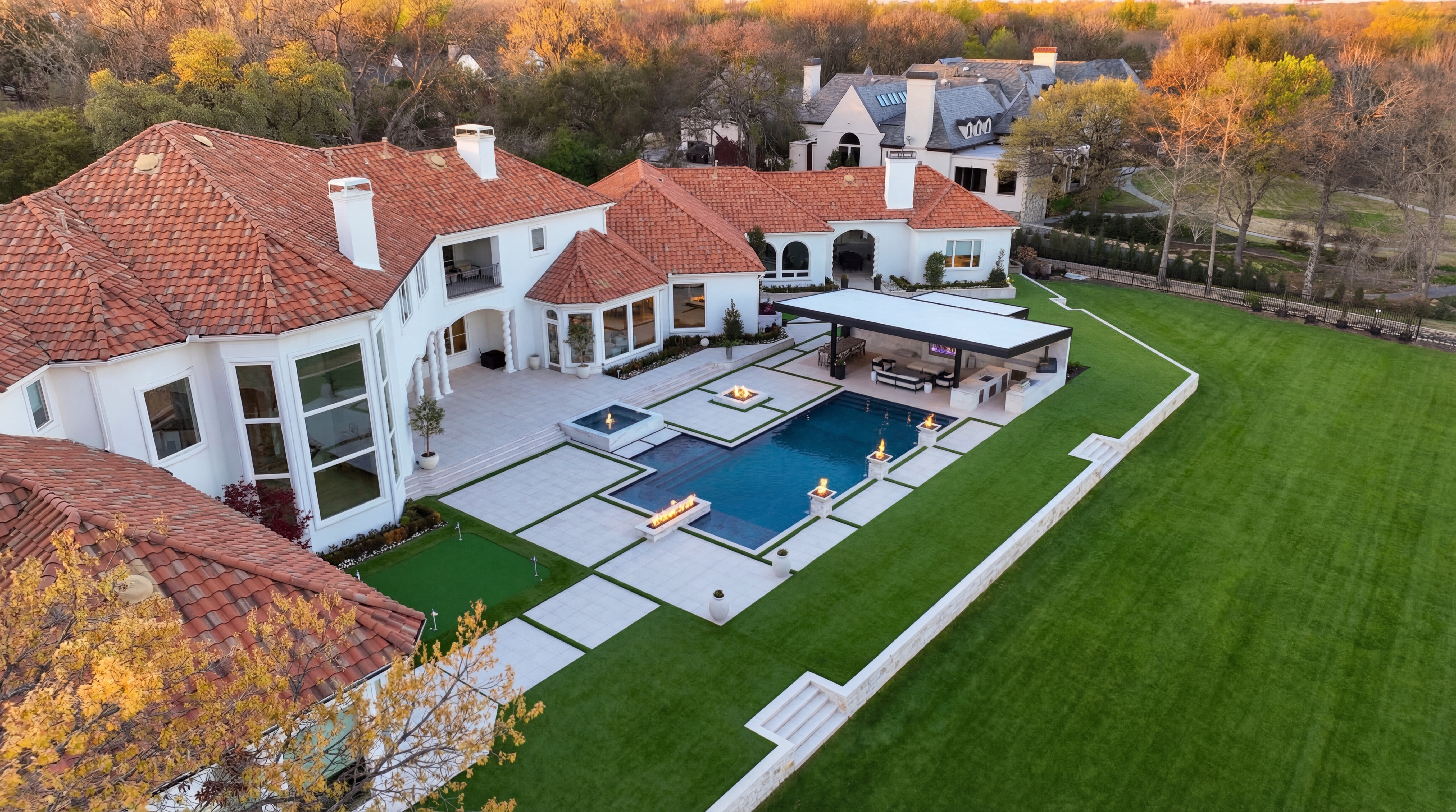 Complete Prestige backyard with full hardscape, landscape lighting, and entertainment zones