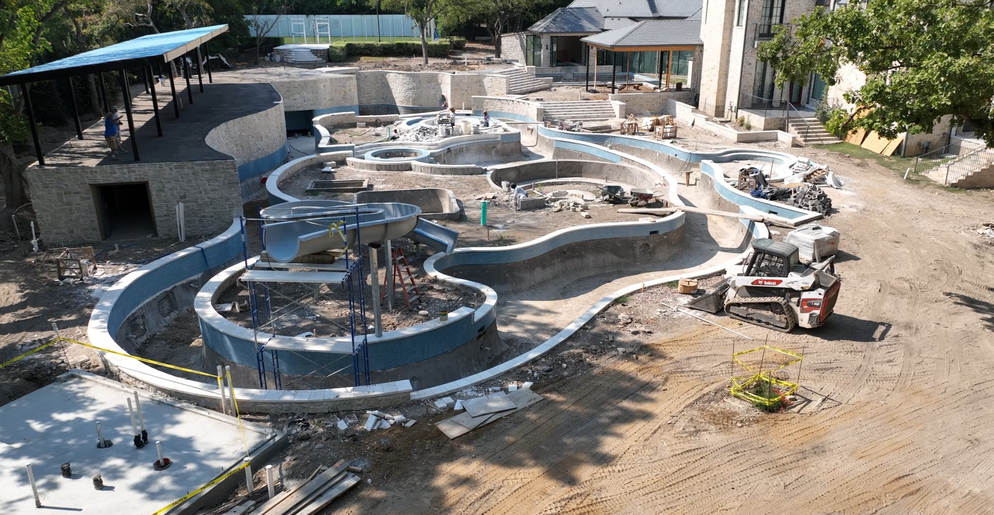 Aerial construction photo showing the massive scale of the Dallas lazy river estate during the build phase