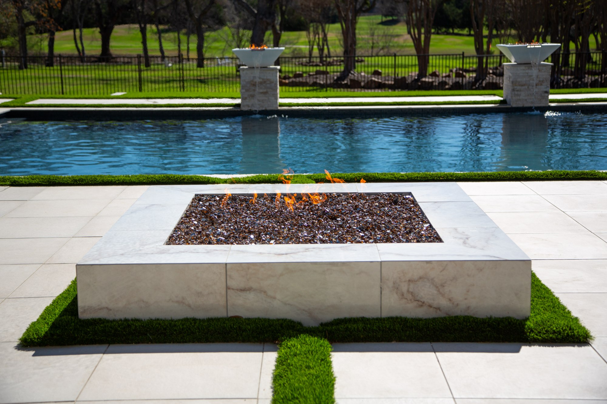 Pool area with fire pit and outdoor lounge seating